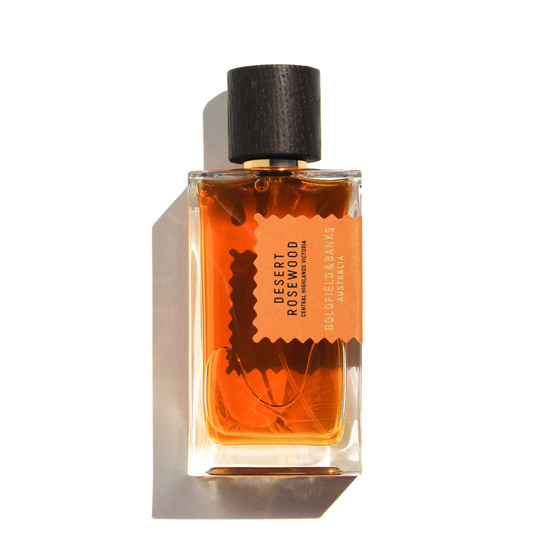 Goldfield & Banks Desert Rosewood perfume bottle with amber liquid and dark wooden cap