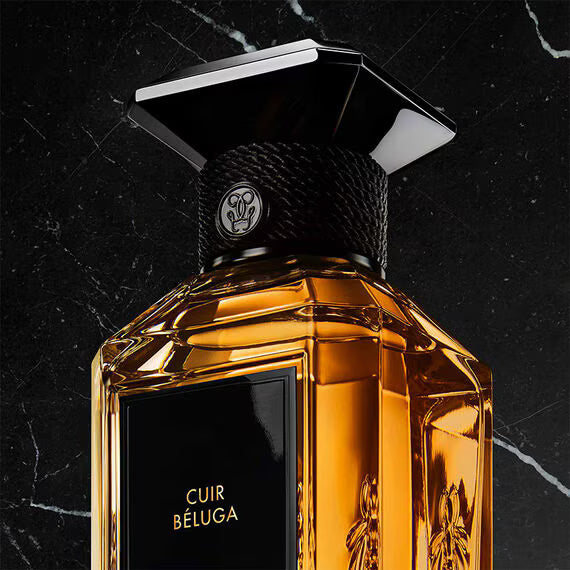 Guerlain Cuir Beluga perfume in an elegant bottle with a rich amber hue against a dark background