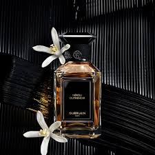 Guerlain Neroli Outrenoir 100ml perfume bottle with elegant design and golden liquid on marble background