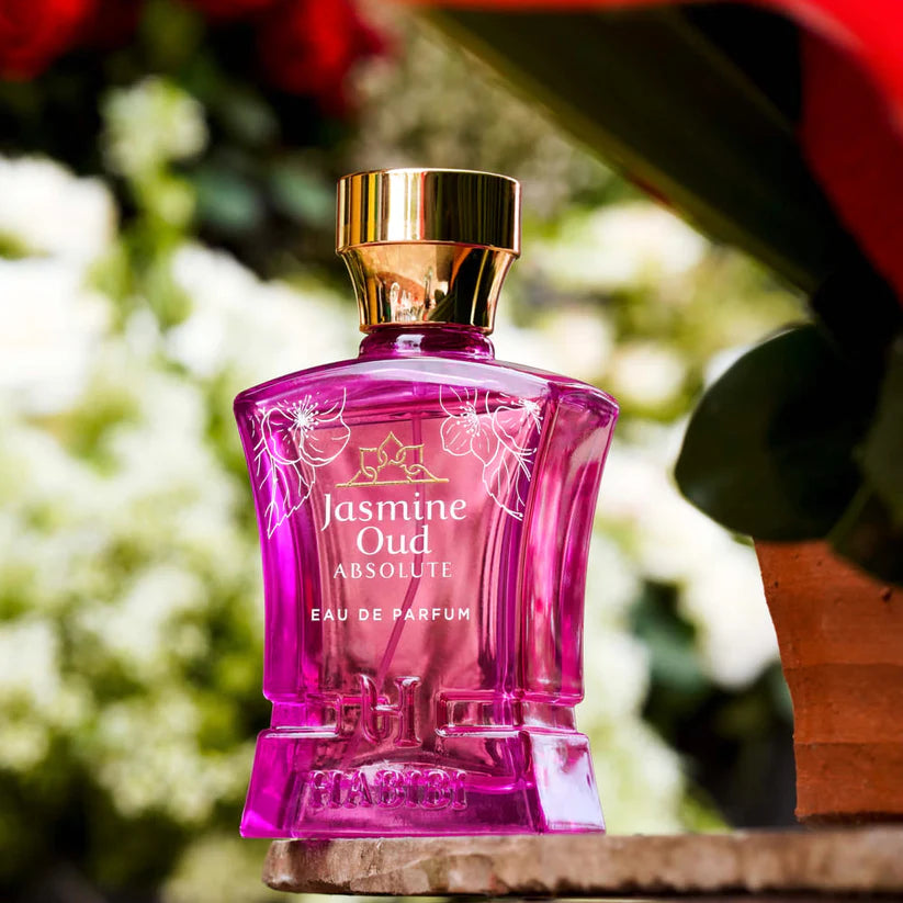 HABIBI NEW YORK Jasmine Oud perfume in pink glass bottle with gold cap on outdoor surface