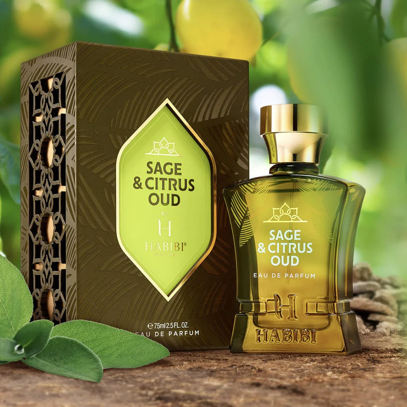 Habibi New York sage and citrus oud perfume bottle and box on natural wooden surface with leaves and citrus background