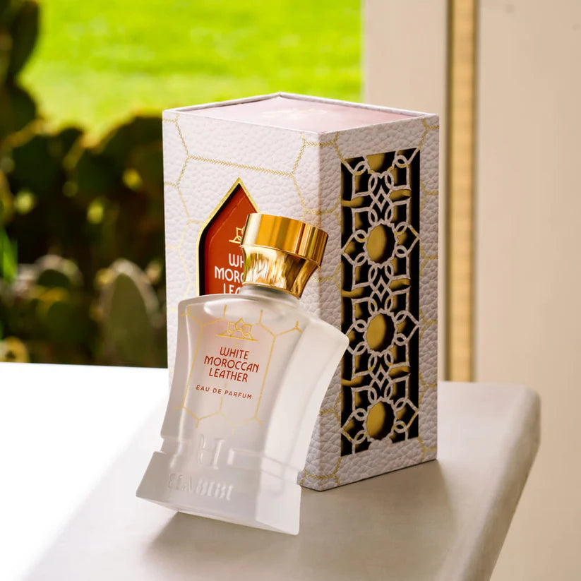 White Moroccan Leather perfume by HABIBI NEW YORK in frosted glass bottle with gold cap on gold stones