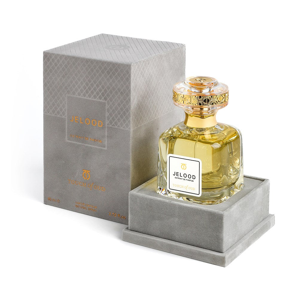 Touch Of Oud Jelood perfume in an elegant glass bottle with gold detailing and a gray luxury box