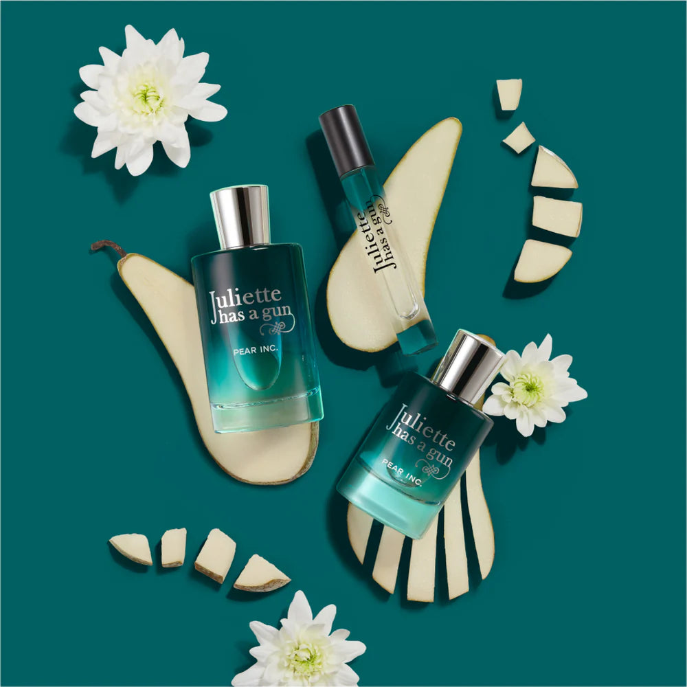 Juliette Has a Gun Pear Inc perfume Dubai featuring elegant bottles and fresh pear slices