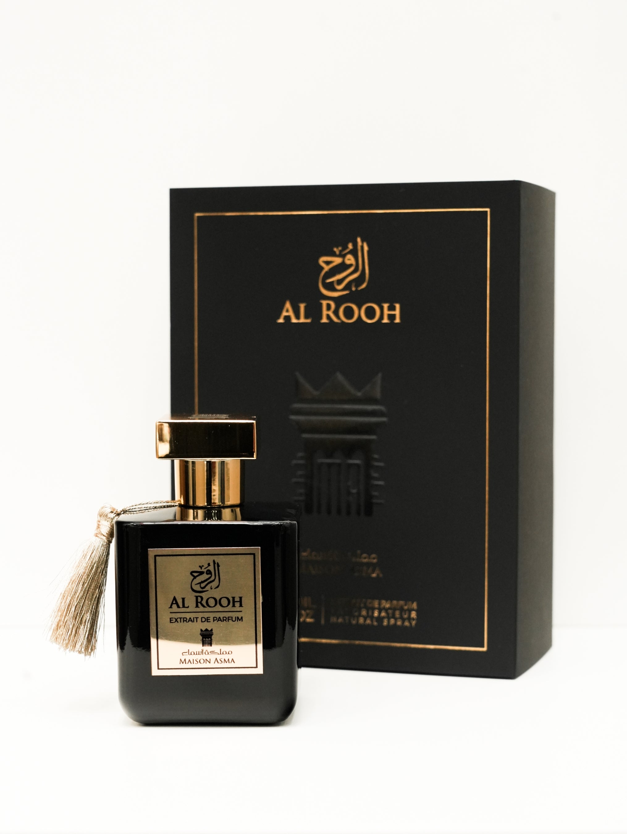 Maison Asma AlRooh extrait de parfum black bottle with gold accents and tassel next to black box