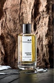 Mancera Cedrat Boise perfume bottle with golden liquid placed against textured wooden background