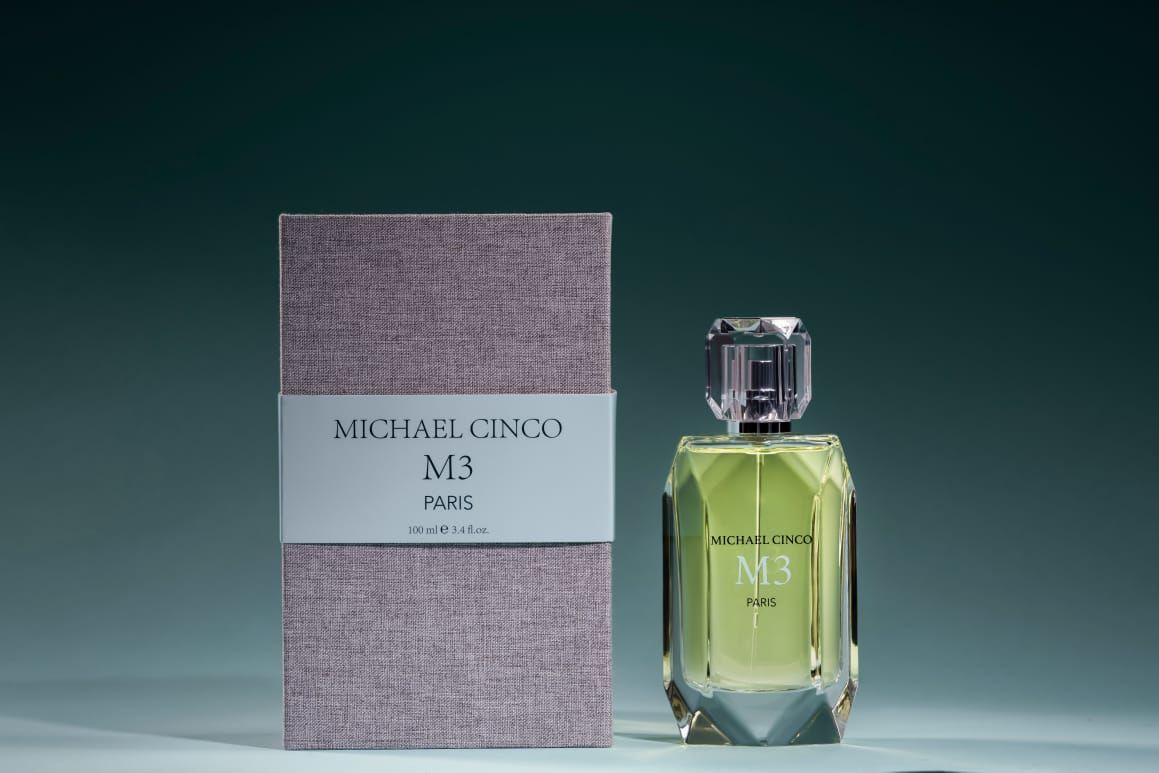 M3 fragrance by Michael Cinco in a faceted glass bottle with matching gray textured box