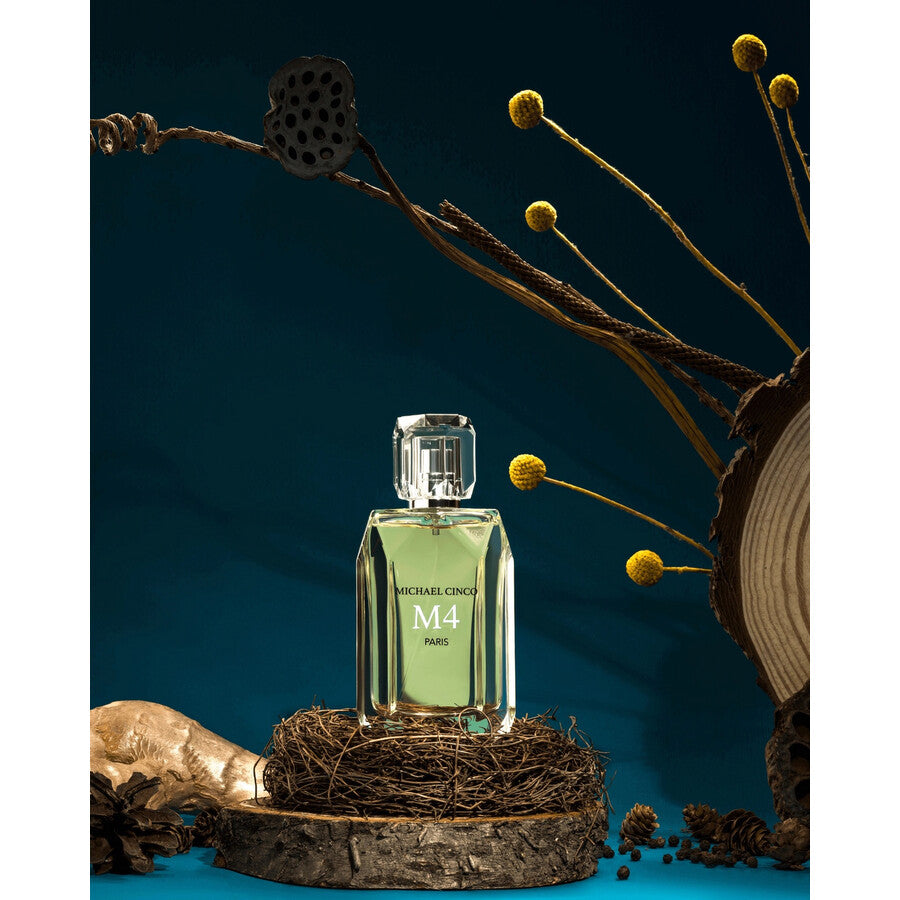 Michael Cinco M4 Paris perfume bottle with green liquid displayed on rustic wooden base and natural dried floral decor