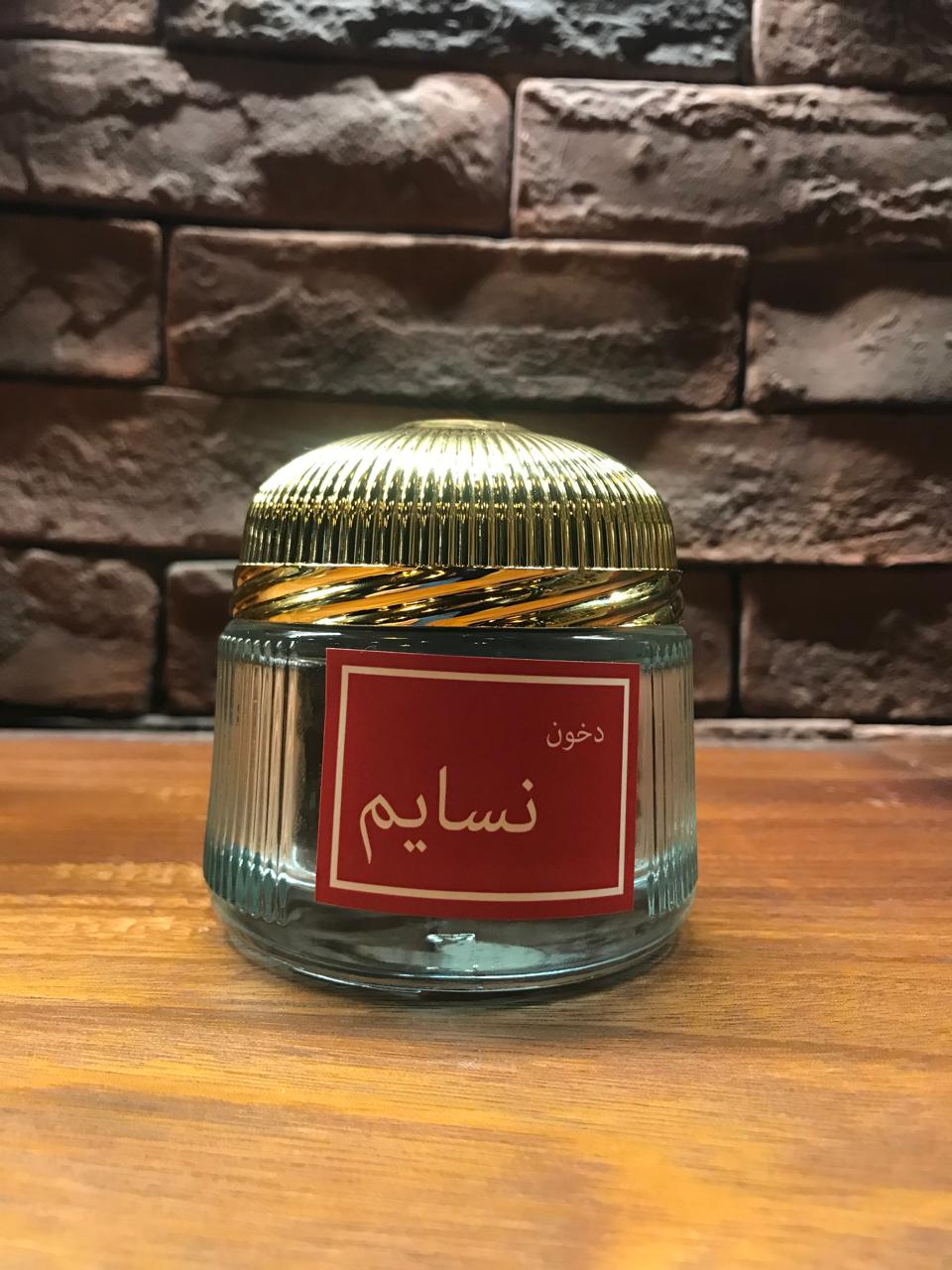 A stylish jar of Nasayem bakhoor Dubai from Atyaab Sheikha Agarwood with a golden lid