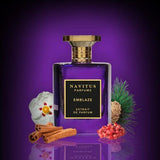 Navitus Perfumes Emblaze extrait de parfum bottle with cinnamon sticks, pinecone, and berries on purple background