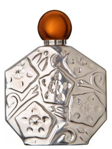Ombre Platine Jean Charles Brosseau perfume in a decorative hexagonal bottle with an orange cap