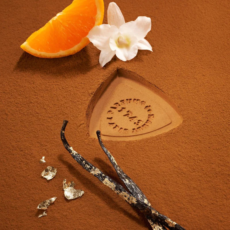 Parfums de Marly Althair EDP 125ml fragrance ingredients with orange slice, white flower, and vanilla pods on brown powder