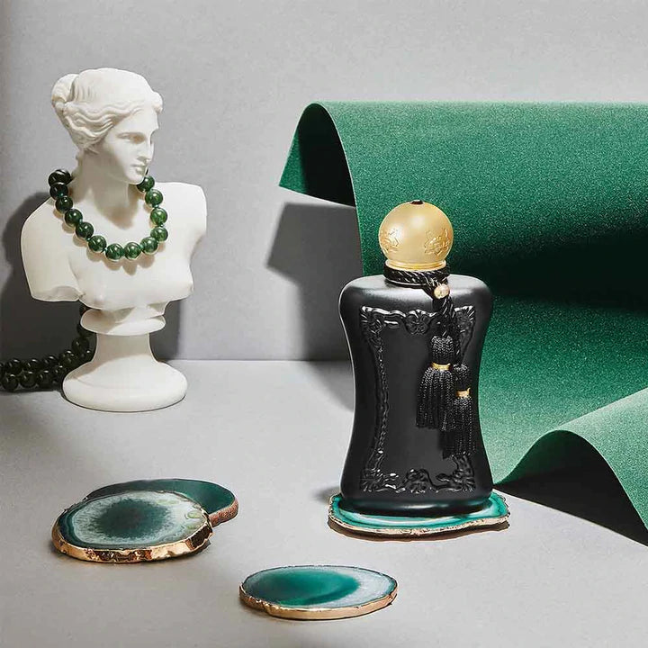 Parfums De Marly Athalia Eau de Parfum black bottle with gold cap displayed with green decor and white bust statue