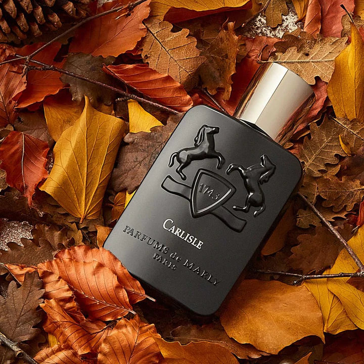 Parfums De Marly Carlisle EDP 125ml black bottle with gold cap on autumn leaves background