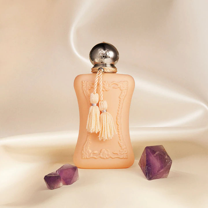 Parfums De Marly Cassili 75ml perfume bottle with decorative tassels and purple crystals on beige background