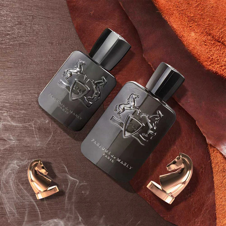 Parfums de Marly Herod Eau de Parfum black bottles with embossed horse logo and gold horse-shaped caps on leather background