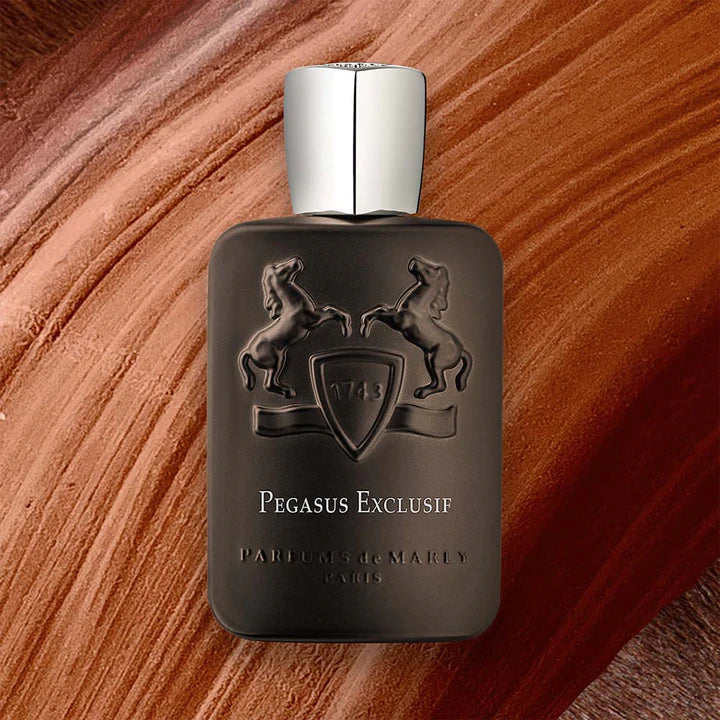 Parfums de Marly Pegasus Exclusif Dubai perfume bottle with embossed design and silver cap on textured background