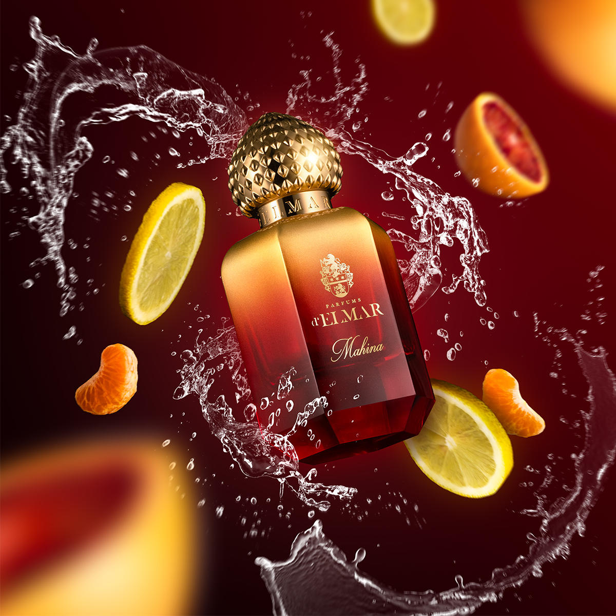 Mahina by Parfums d'Elmar perfume bottle with citrus fruit slices and water splash on red background