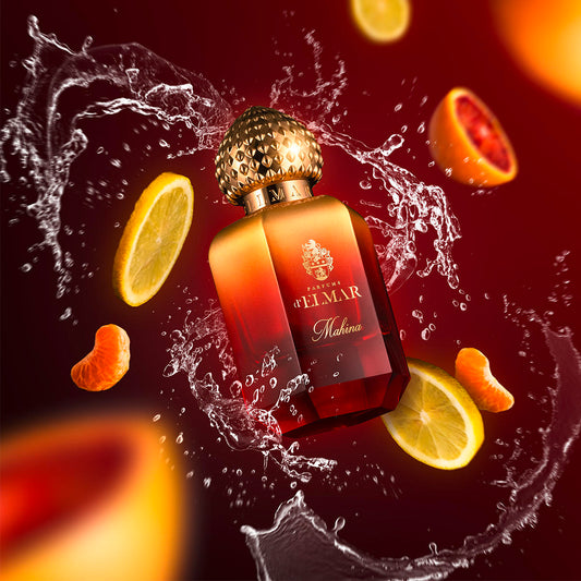 Mahina by Parfums d'Elmar perfume bottle with citrus fruit slices and water splash on red background