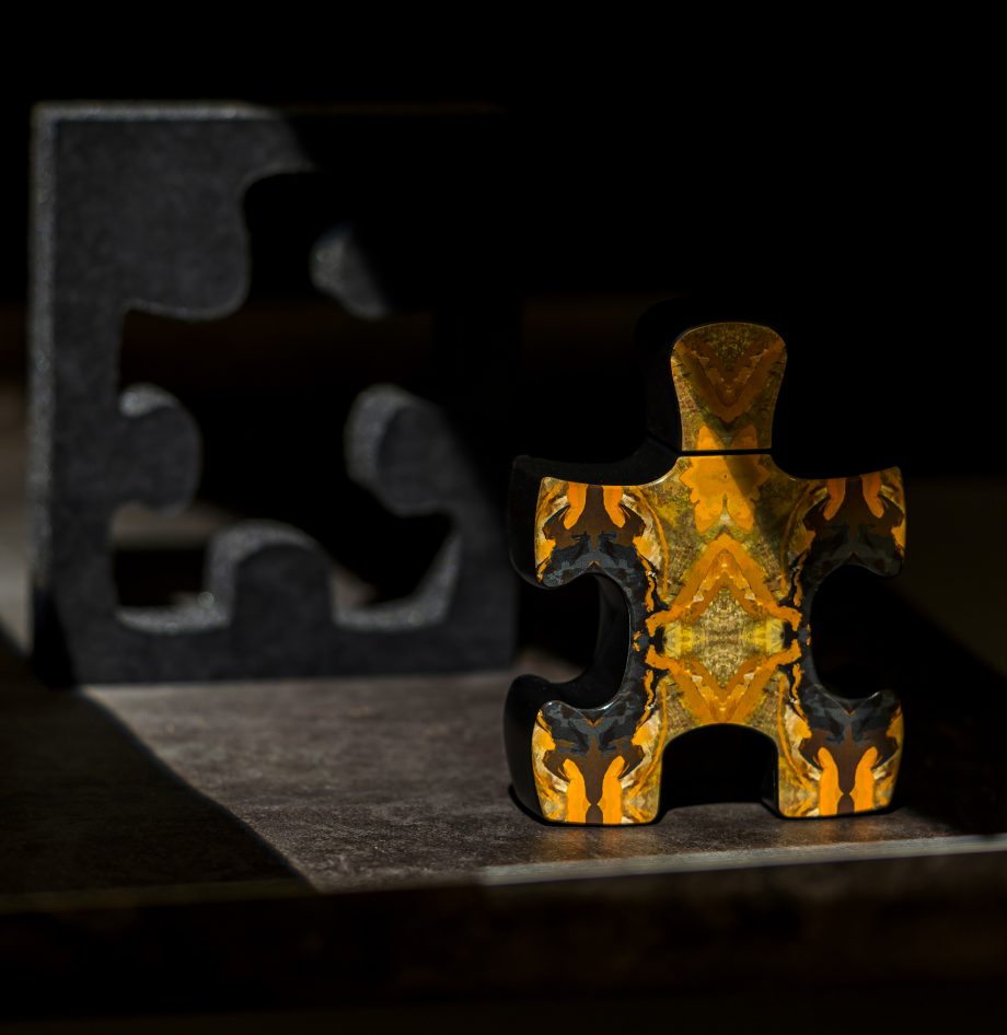 Puzzle Daylight perfume bottle shaped like a colorful puzzle piece with dark puzzle piece background