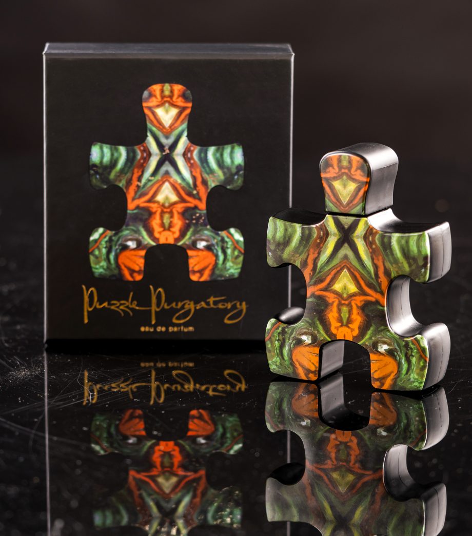 Puzzle Perfume Puzzle Purgatory perfume bottle shaped like a colorful puzzle piece with matching box
