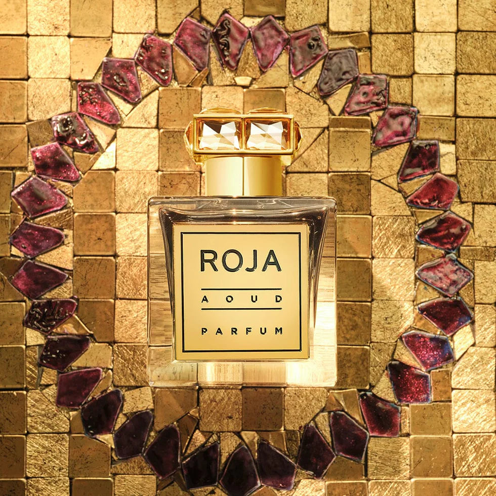 Roja Aoud perfume 100ml displayed in an elegant gold setting with intricate design details