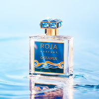 Roja Parfums Oceania Eau De Parfum bottle with blue and gold label on water surface background