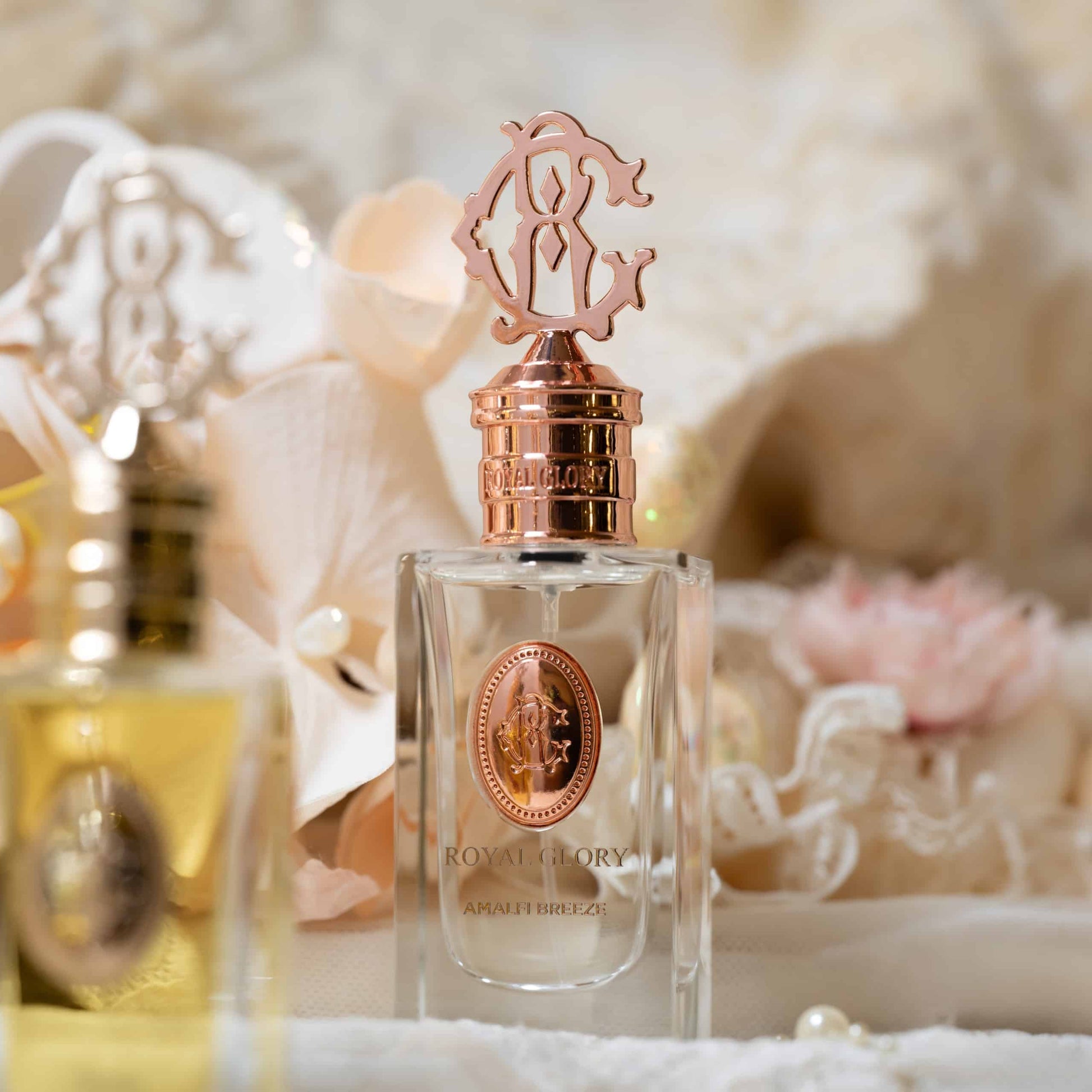 ROYAL GLORY Amalfi Breeze perfume Dubai in a clear glass bottle with intricate rose gold cap and emblem