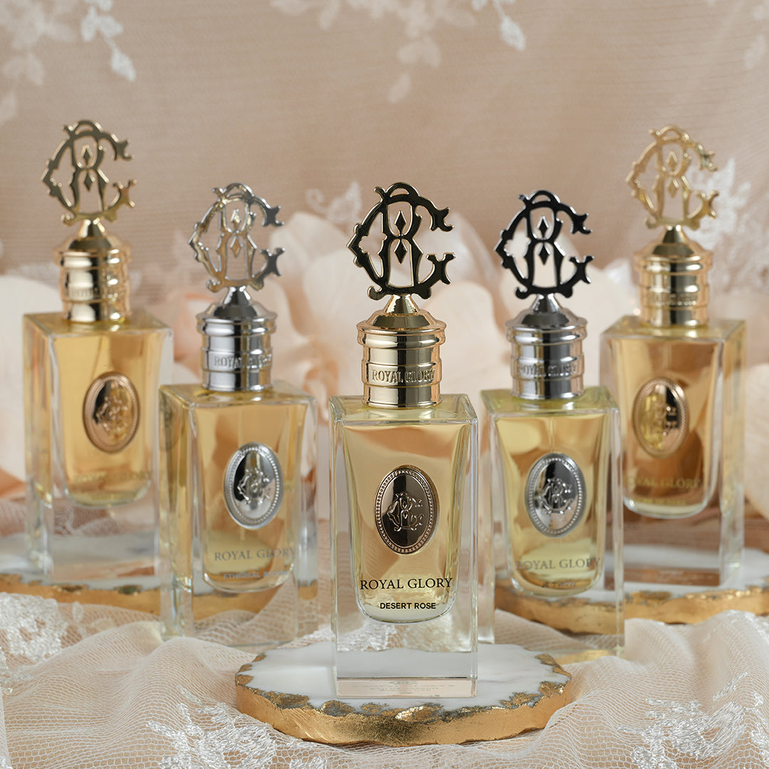 Royal Glory Desert Rose perfume 60ml bottles with elegant gold and silver caps displayed on lace fabric