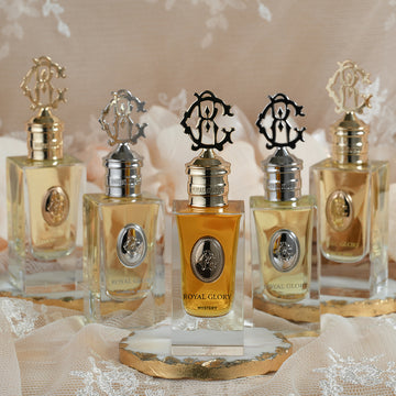 ROYAL GLORY MYSTERY 60ml exclusive scent perfume bottle with gold and silver caps displayed on lace fabric