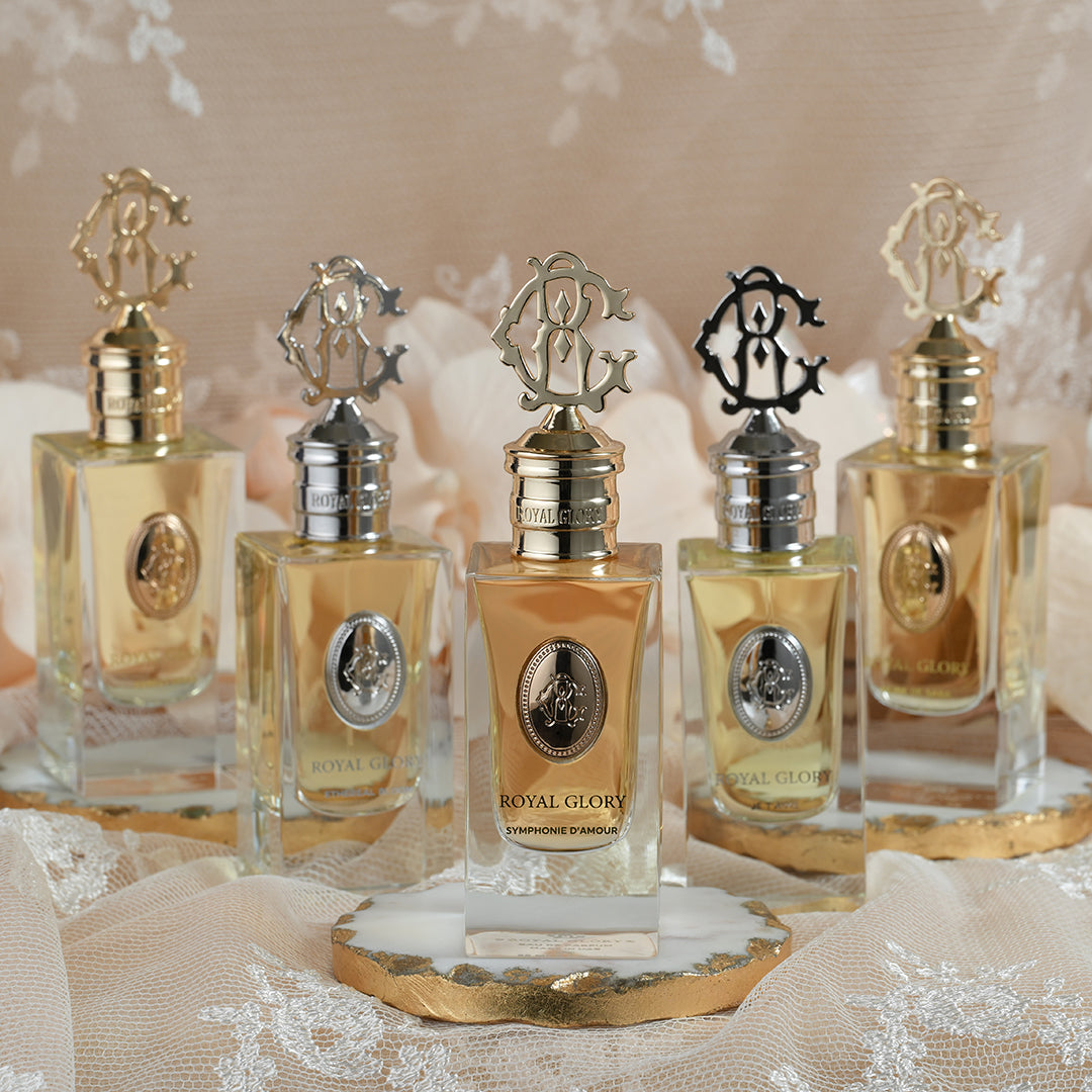 Royal Glory Symphonie d’Amour perfume 60ml bottle with elegant gold and silver caps displayed on lace fabric