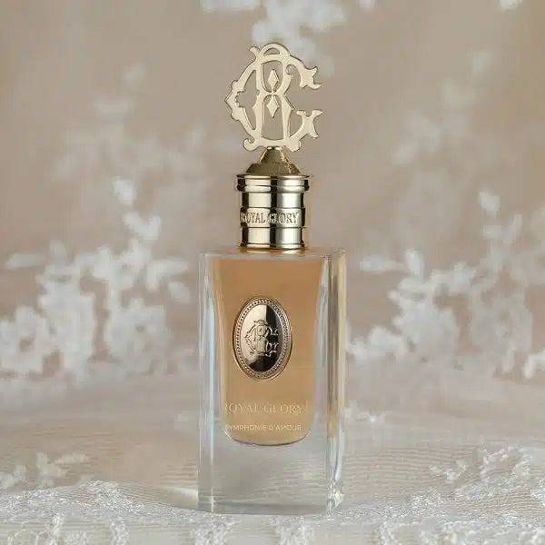 Royal Glory Symphonie d’Amour perfume 60ml bottle with elegant gold and silver caps displayed on lace fabric