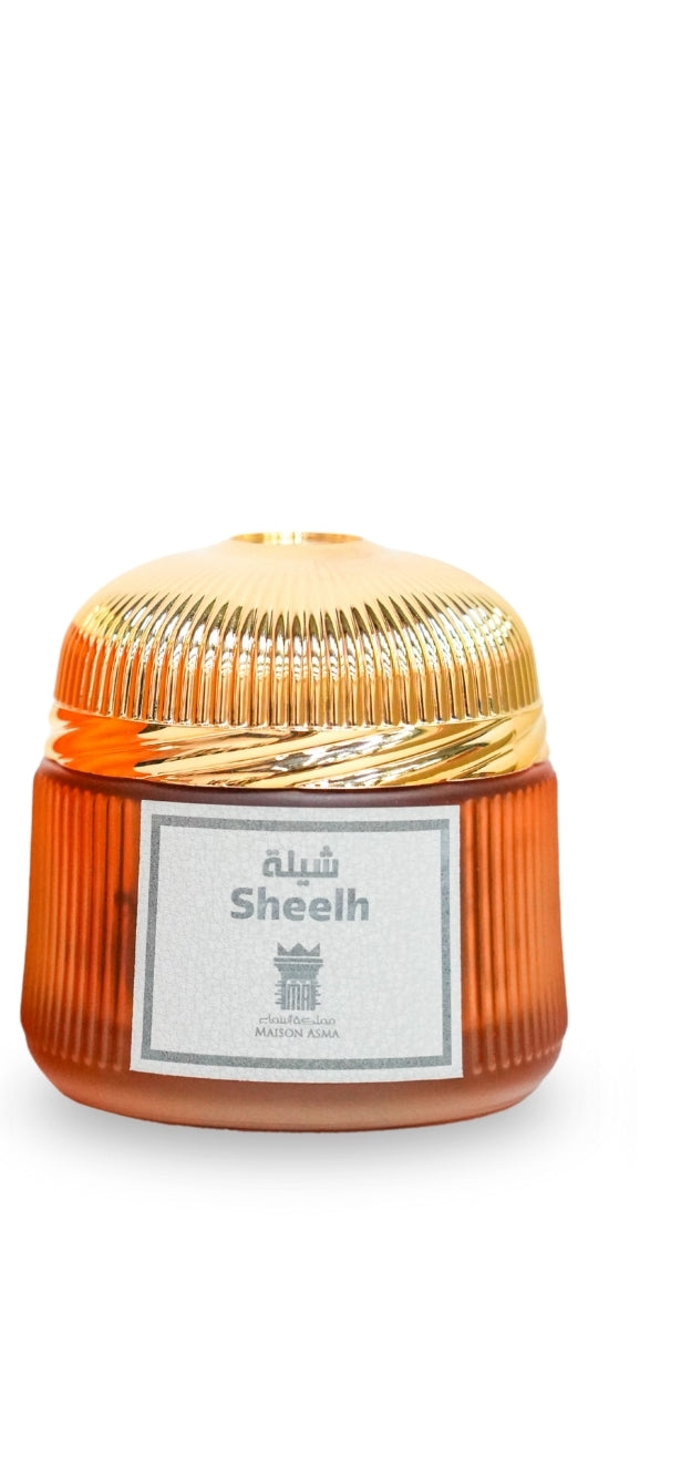 Maison Asma Sheelah Dhakoun bakhoor perfume in an amber ribbed glass jar with a gold lid