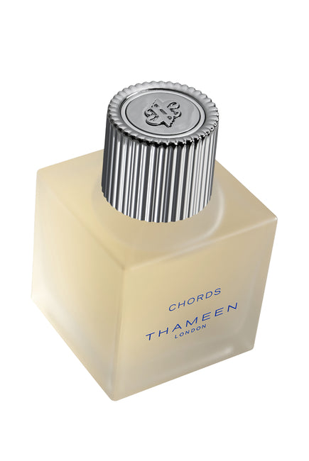 Thameen Chords Cologne Elixir perfume bottle with frosted glass and silver ribbed cap by Thameen London fragrance