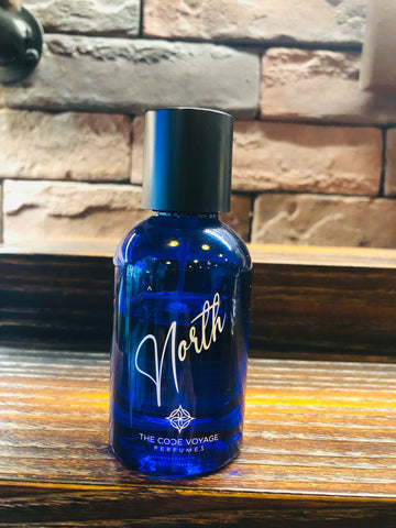 NORTH perfume by THE CODE VOYAGE in a blue bottle with a sleek design and black cap