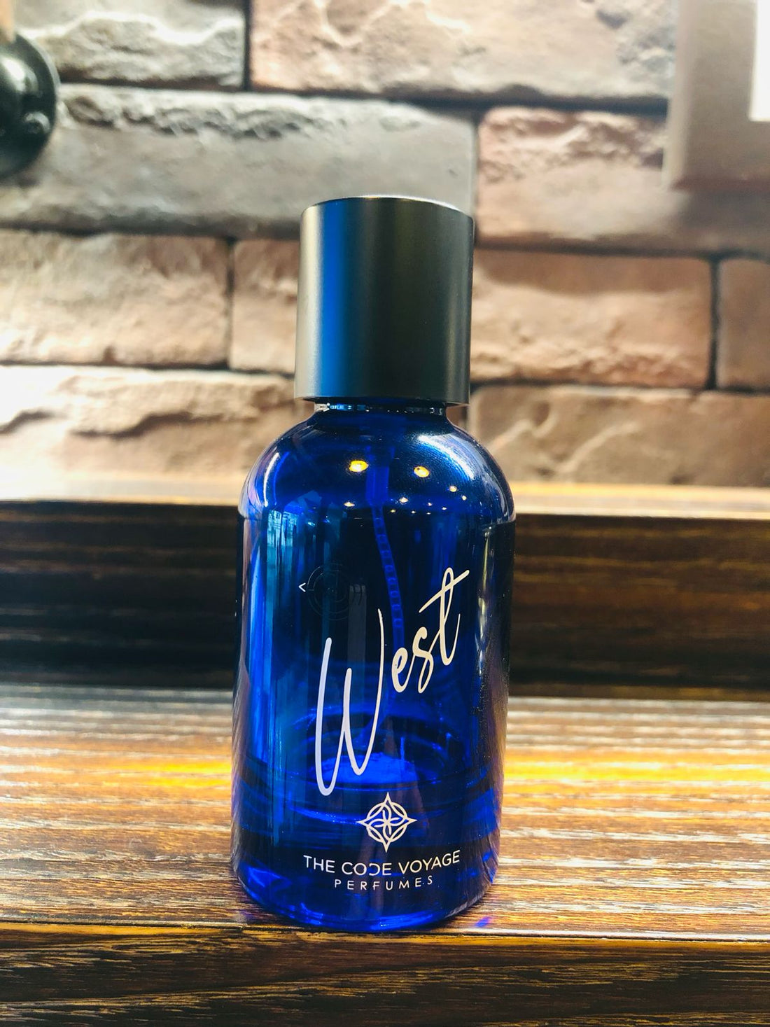 THE CODE VOYAGE West niche fragrance in a blue bottle, perfect for an elegant scent experience