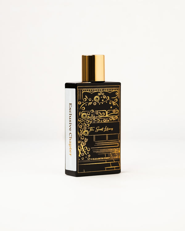 71 Elizabeth Street eau de parfum by The Scent Library, a black bottle with a gold cap and ornate gold line-art of a storefront, Exclusive Chapter side label