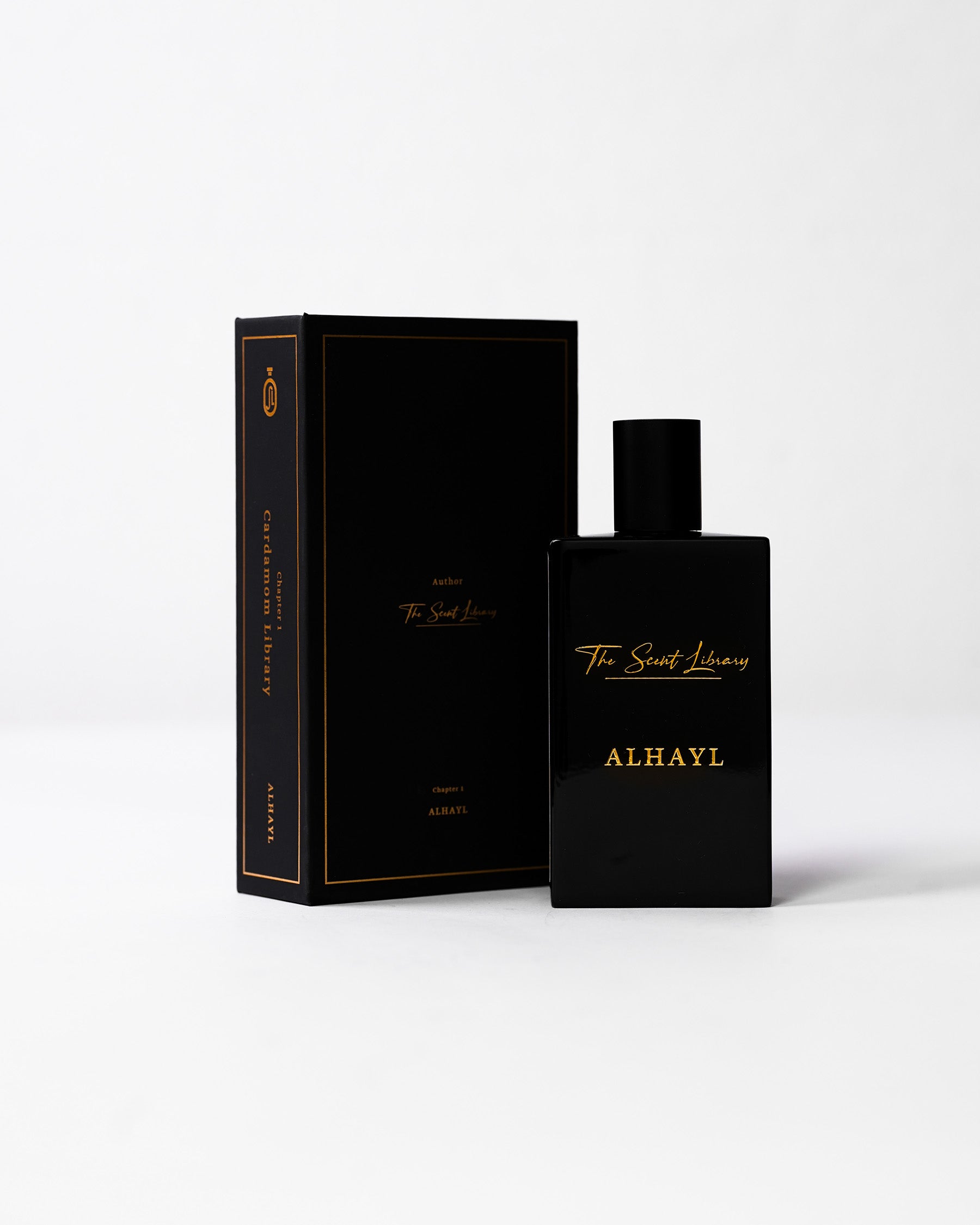 ALHAYL eau de parfum bottle beside its black book-shaped presentation box with gold lettering, by The Scent Library