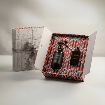 The Elite Set by Baytak, a room freshener and a black Tayar perfume in a red Sadu-patterned gift box beside a white ribboned box, by The Scent Library