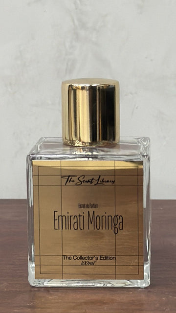 The Scent Library Emirati Moringa perfume in a clear glass bottle with gold accents