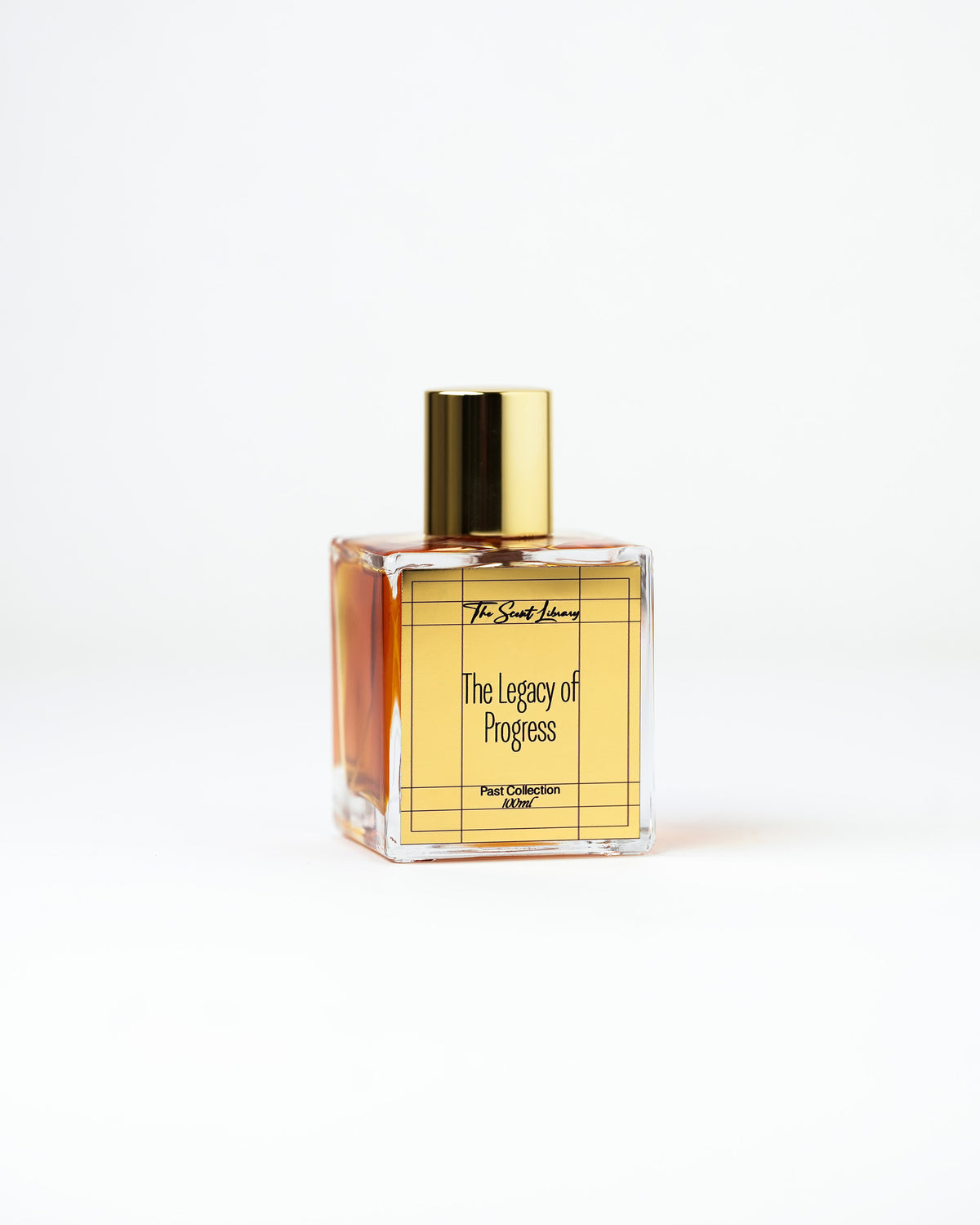 The Legacy of Progress perfume by The Scent Library, a clear square glass bottle with a gold cap, Past Collection Collector's Edition