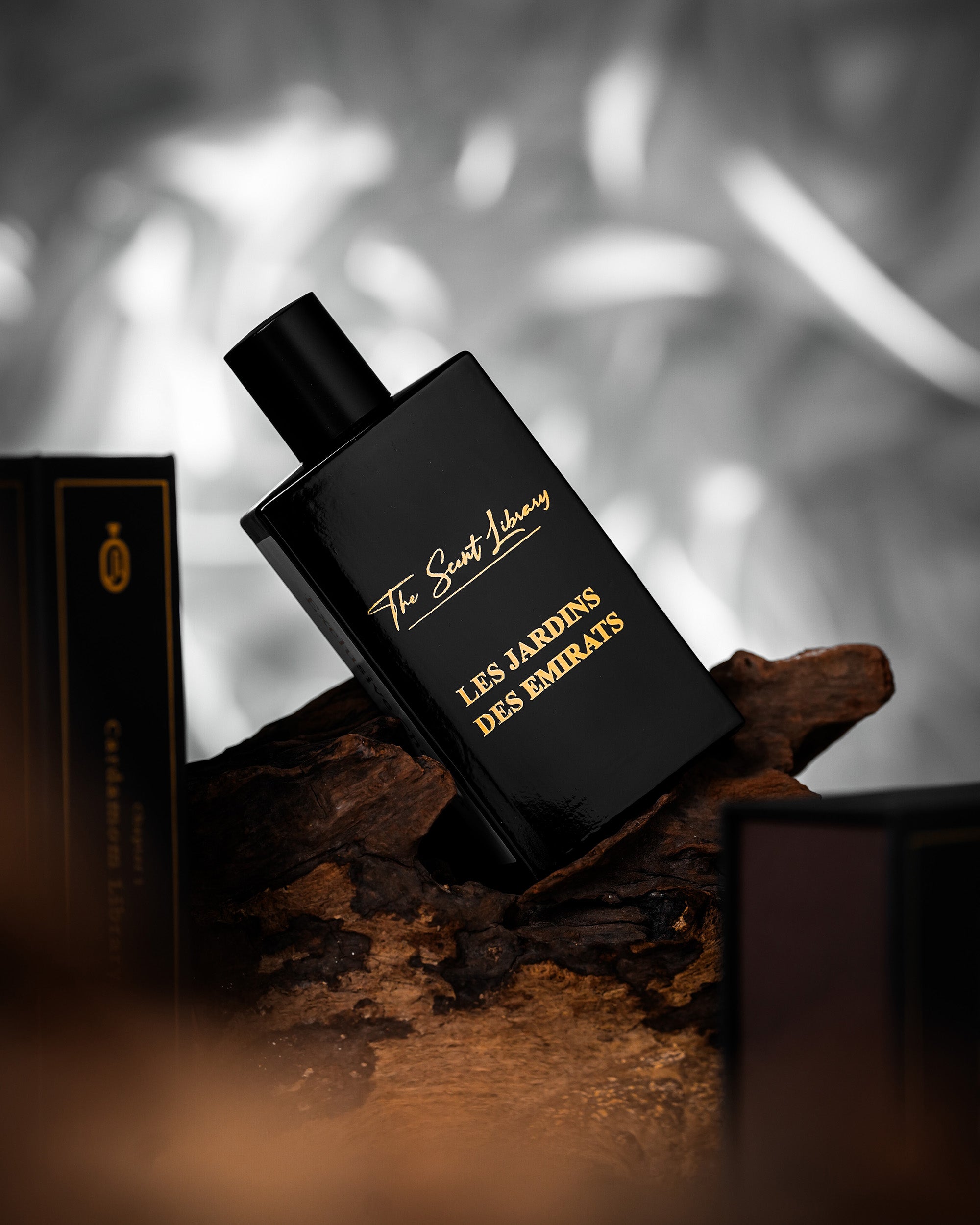 Les Jardins des Emirats eau de parfum by The Scent Library, a black bottle with gold lettering shown in a lifestyle setting