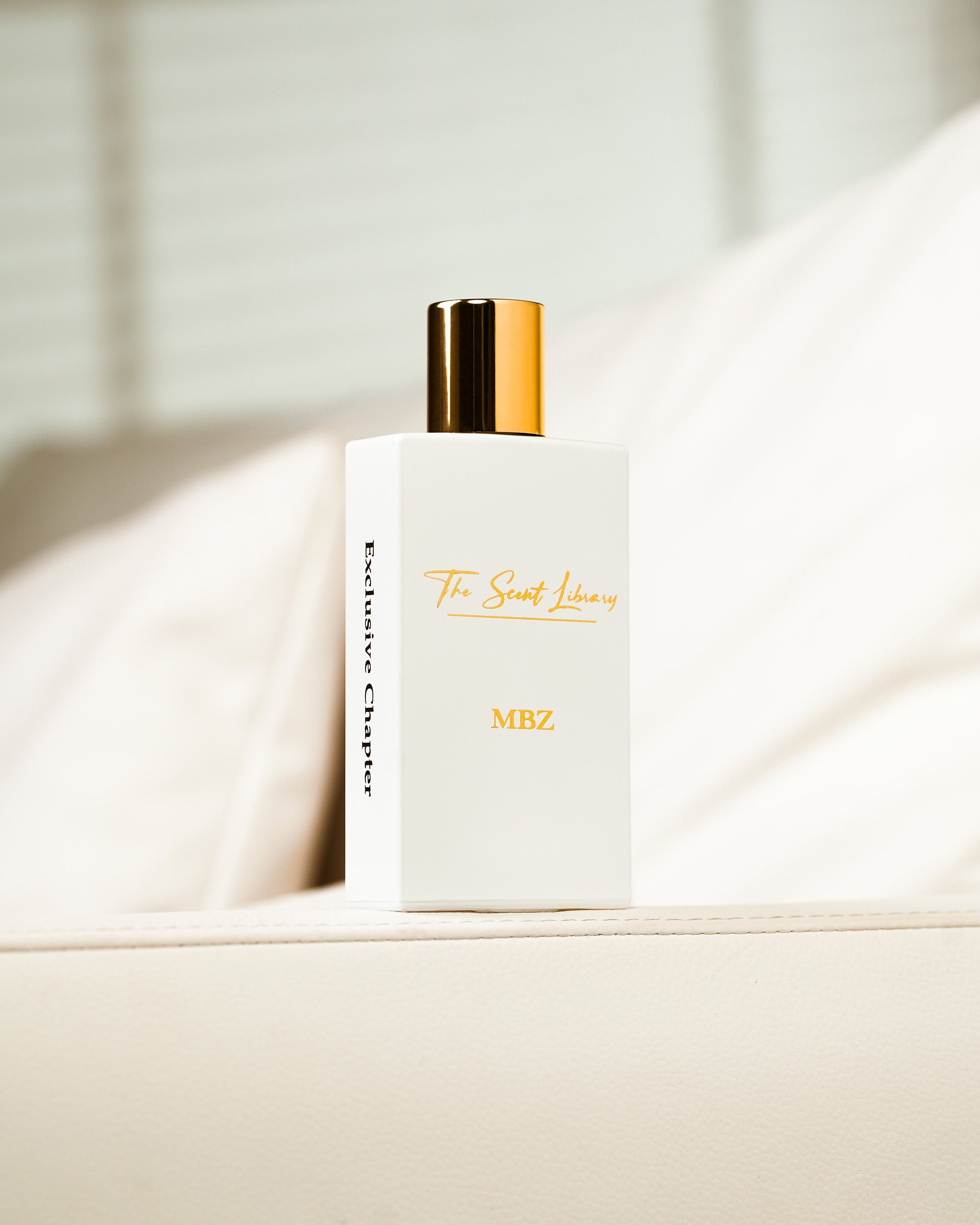 MBZ eau de parfum by The Scent Library, a white gold-capped bottle in a soft-lit lifestyle setting