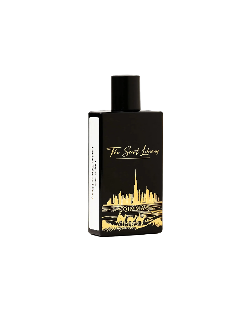 Qimma Collector's Edition by Julien Rasquinet at The Scent Library, a black bottle with gold Dubai skyline and camel artwork, Chapter 2020s Leather Tobacco Library