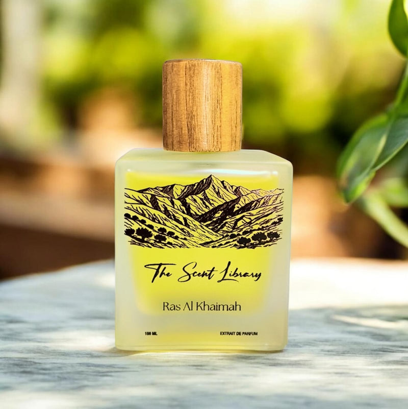 Ras Al Khaimah extrait de parfum by The Scent Library, a frosted glass bottle with a wooden cap and an illustrated label of the Hajar mountains