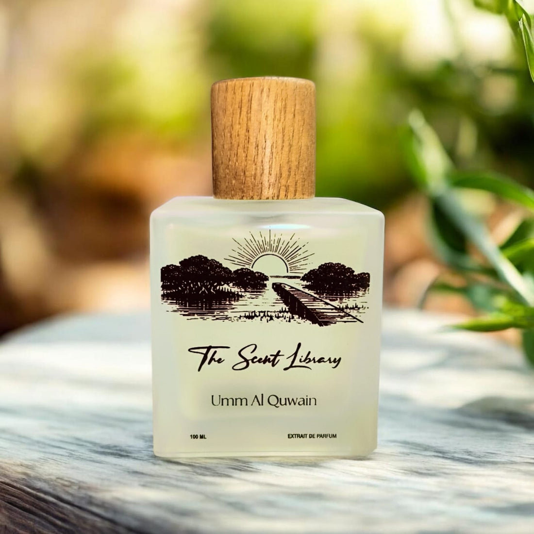 Umm Al Quwain extrait de parfum by The Scent Library, a frosted glass bottle with a wooden cap and an illustrated label of mangroves, a lagoon jetty and sunrise