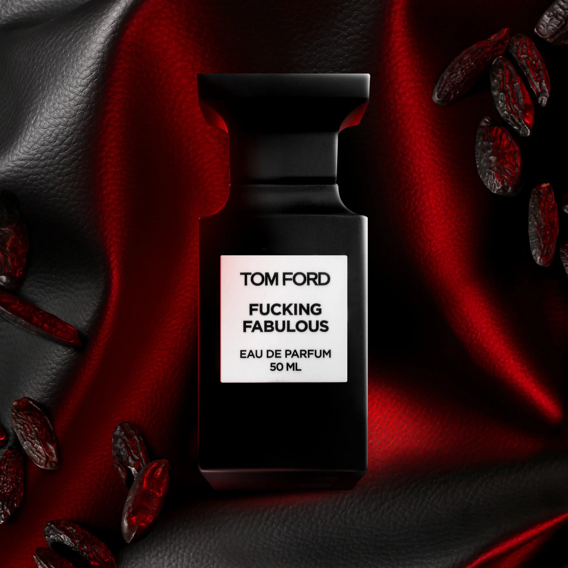 Tom Ford Fucking Fabulous 50ml Eau de Parfum bottle surrounded by dark red accents and fragrant beans