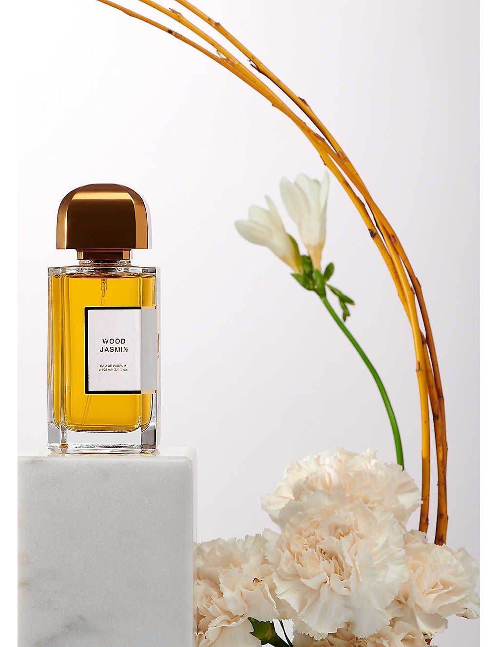 BDK Parfums wood jasmine eau de parfum 100ml bottle with cream flowers and decorative sticks